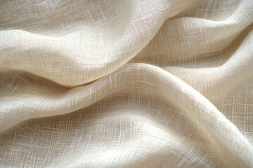 Close-up of soft beige linen fabric with natural texture and gentle folds
