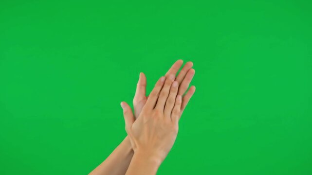 Hands clapping on a solid green screen background.