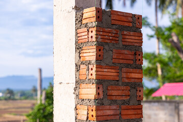 Bricklaying for house column construction.