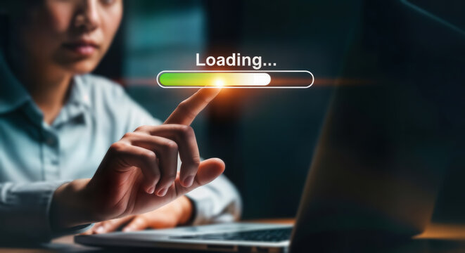 A persons finger is touching a loading bar on a computer screen, representing technology, progress, and digital processes in a modern business or work environment - Powered by Adobe