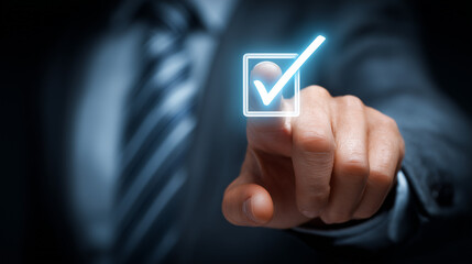 Businessman touching blue checkmark icon on virtual screen for quality control, digital technology and business concept. Business man's finger points to online proven service with high standard.