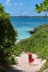 赤いドレスの女性と青い海