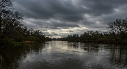 Brooding Storm Clouds Gather Over a Wide, Reflective River