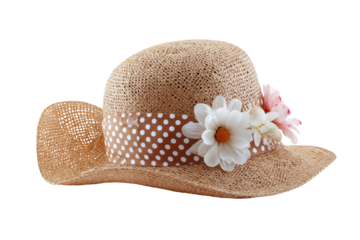 A light beige straw hat, angled, features a brown and white polka dot ribbon band around the crown.  Decorative white daisies and pink blossoms adorn the band