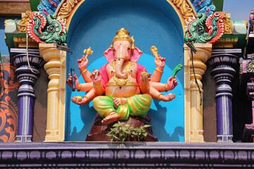 Eight-armed Ganesha statue in niche of Hindu temple, close-up of detailed carving, traditional Indian deity of wisdom and prosperity, religious art, Hinduism culture