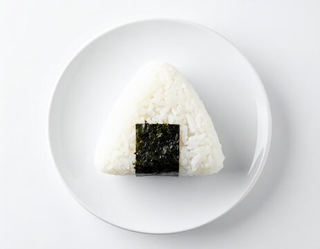 Minimalist Japanese onigiri rice ball on white plate, top view, clean background
