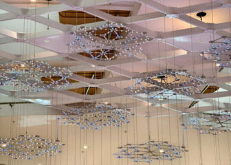 A beautiful large chandelier gracefully hangs from the ceiling of a building