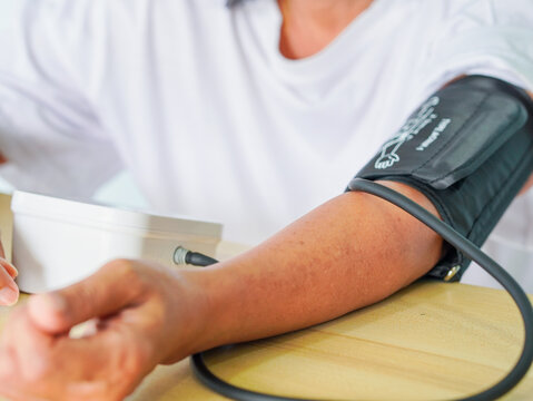 Close up arm people test blood pressure. Senior woman check high blood pressure at hospital concept healthcare, healthy lifestyle people wellness health.Elderly care female. Patient treatment home car
