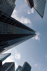 bottom view of the tall skyscrapers of the business district of a modern city