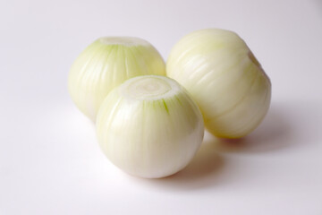 Peeled white onion on white background