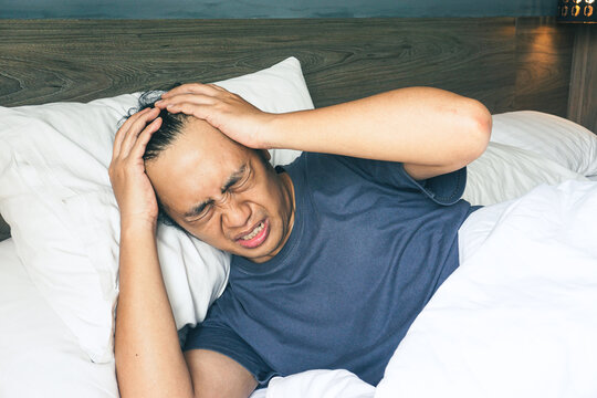Portrait of handsome asian man feel resigned at bed room - Powered by Adobe