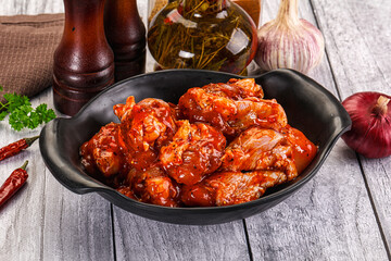 Raw marinated buffalo chicken wings