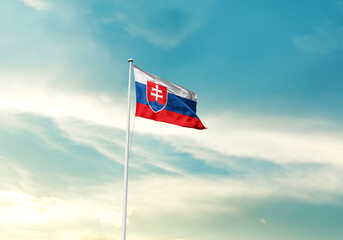 Slovakia flag is waving on a tall flagpole among the clouds. Slovakia national flag for independence day.