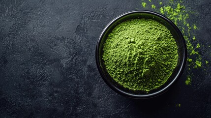 Heaped matcha powder in black bowl centered on clean dark surface, perfect for tea ceremony concept