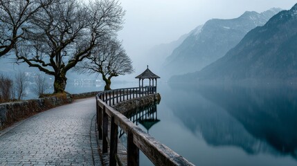 serene misty winter lake, calm water reflecting foggy mountains, leafless trees, paved stone path with wooden railing along the lake, traditional wooden gazebo