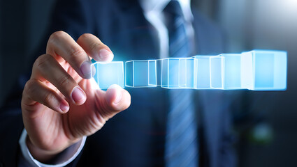 Hand interacting with glowing blue digital cubes business technology