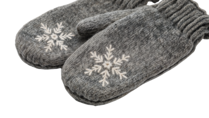 Cozy gray wool mittens with white snowflake embroidery for winter warmth and seasonal comfort on the transparent background