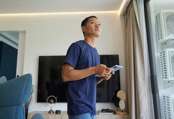 Worker with tablet computer checking alarm system