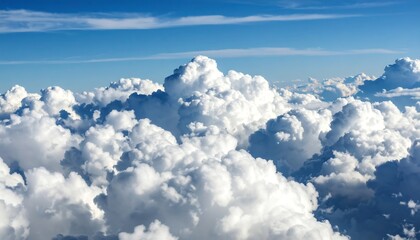 Aerial view of fluffy cumulus cloudscape, bright blue sky above
