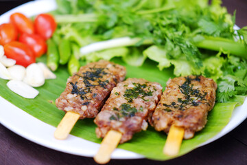 Close up grilled pork with vegetable on banana leaf. Tradition food of Thailand

