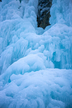 Winter ice climbing crag in the Alps. Imst Pitztal area famous for its frozen waterfalls in winter. Huge ice stalactites hanging on the wall of a canyon in the Alps. Winter ice climbing extreme sports