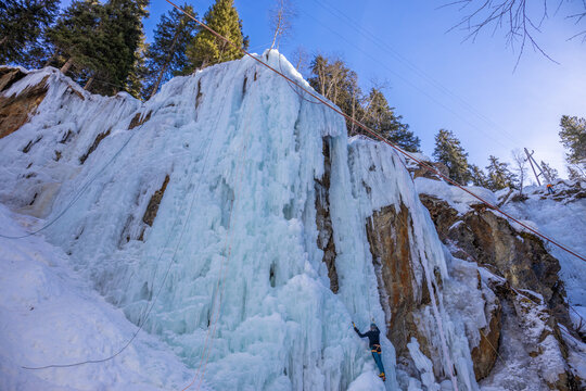 Winter ice climbing crag in the Alps. Imst Pitztal area famous for its frozen waterfalls in winter. Huge ice stalactites hanging on the wall of a canyon in the Alps. Winter ice climbing extreme sports