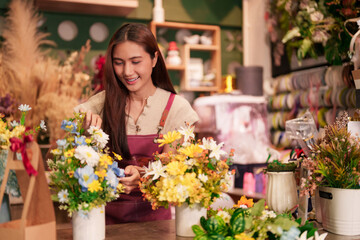 Asian adult florist curates colorful flower arrangements in her bustling shop crafting beautiful bespoke bouquets