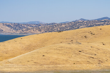 The Diablo Range is a mountain range in the California Coast Ranges. Mediterranean climate / dry summer climate. San Luis Reservoir Viewpoint Parking, Pacheco Pass Hwy, Merced County, California. 
