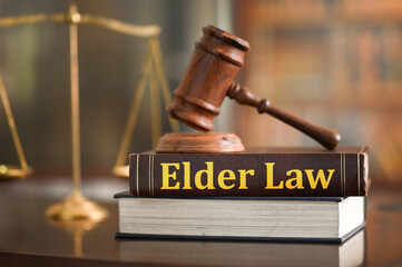 Elder Law education concept. judge gavel on elder law books and scales of justice  on desk of lawyer.