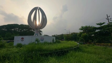 Sunset Through Circular Structure Surrounded by Grass at Dhaka, 5 July, 2025
