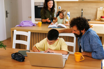 Family doing homework and homeschooling in kitchen