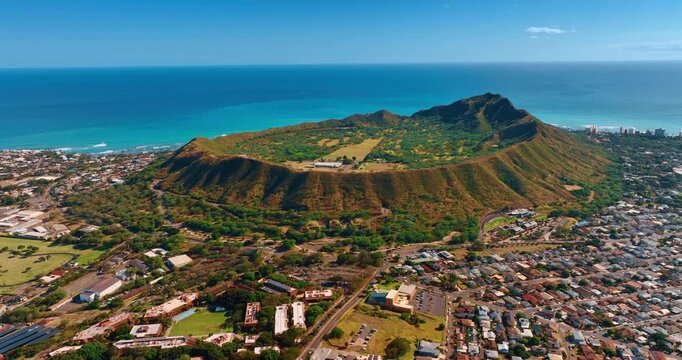 Distancing from the famous landmark of Honolulu - Diamond Head Crater. Scenery of Honolulu, Hawaii and the Pacific Ocean. Aerial view.