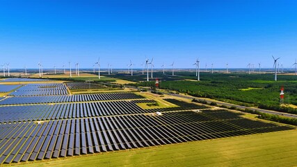 Vast solar panels fields producing energy from sunlight. Wind farms make green energy from wind. Alternative power production. Aerial view. - Powered by Adobe