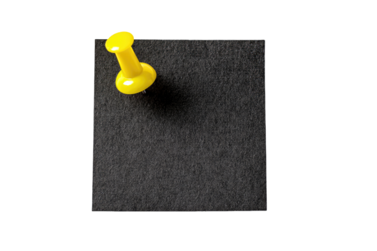 A bright yellow pushpin is affixed to a dark gray square memo pad