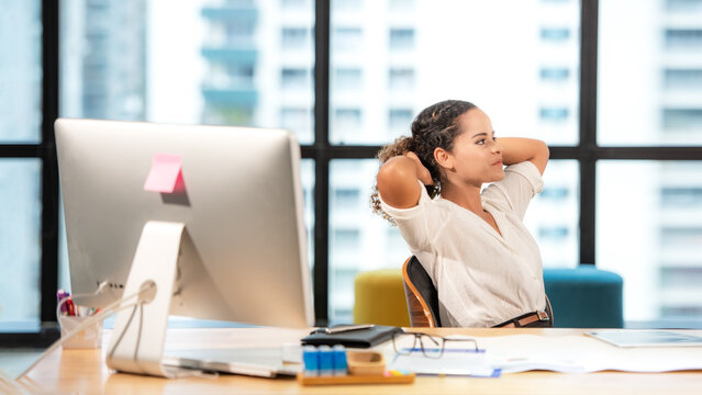 Businesswoman caucasian relax time after work hard. woman working and analysis report on financial data in the modern office, relax and rest time after work. Business Concept - Powered by Adobe