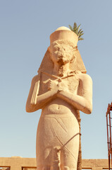 Statue of pharaoh with crossed arms at Karnak Temple in Luxor Egypt 28 February 2025
