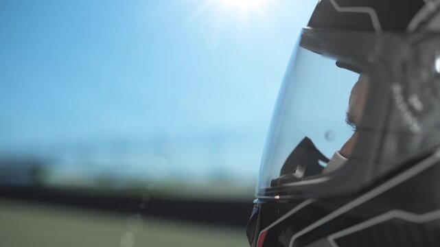 Intense video of a helmeted driver on the track, sharp focus, high-speed action captured.