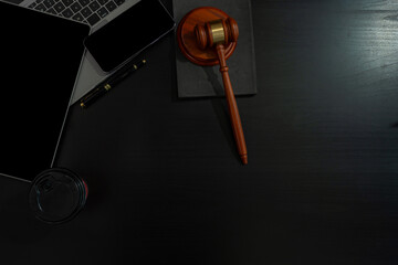 Justice and law concept.Lawyer workplace with laptop and documents with dark wooden in office.