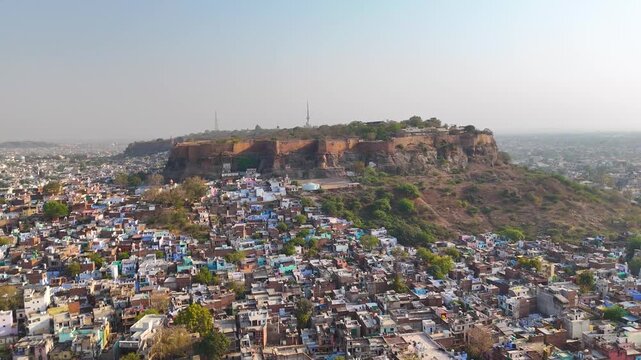 Aerial shot of a fort on mountain surrounded by city buildings in india,Gwalior fort