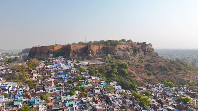 Aerial shot of a fort on mountain surrounded by city buildings in india,Gwalior fort