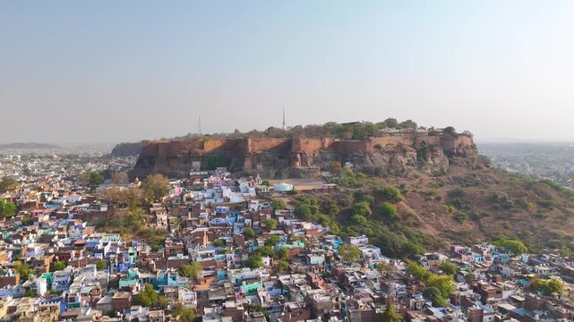 Aerial shot of a fort on mountain surrounded by city buildings in india,Gwalior fort