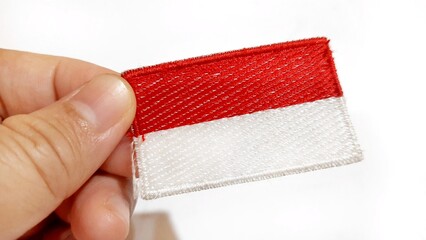Hand Holding an Indonesian Flag Patch. Happy Anniversary Independence Day of Indonesia, August 17Th 1945