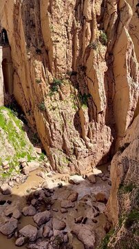 Flooded cliffs in El Caminito del Rey with rust-colored water after heavy rainfalls. Rare view caused by storm runoff and mineral-rich erosion.