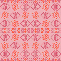 A repeating pattern in shades of red on a pink background, featuring geometric shapes and intricate designs