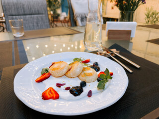 Delicious dessert plate beautifully arranged at garden dining setting in the evening