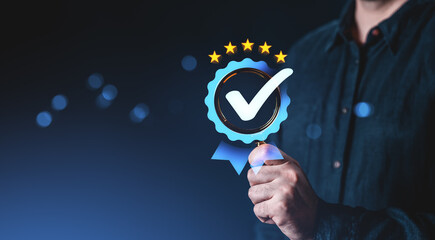 Businessman holding blue checkmark badge with five stars symbolizing quality assurance on dark gradient background, representing trust and certification concept.