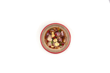 Seasoned fish sauce consists of chili peppers and finely chopped shallots.