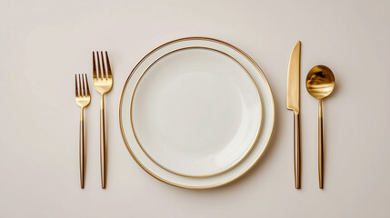 Elegant oval white plate with gold trim and gold cutlery set