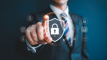 Businessman Pointing at Digital Shield Icon, Cybersecurity Concept