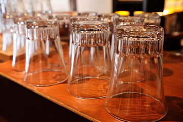 Upside-Down Glasses Arranged on Wooden Table in Café